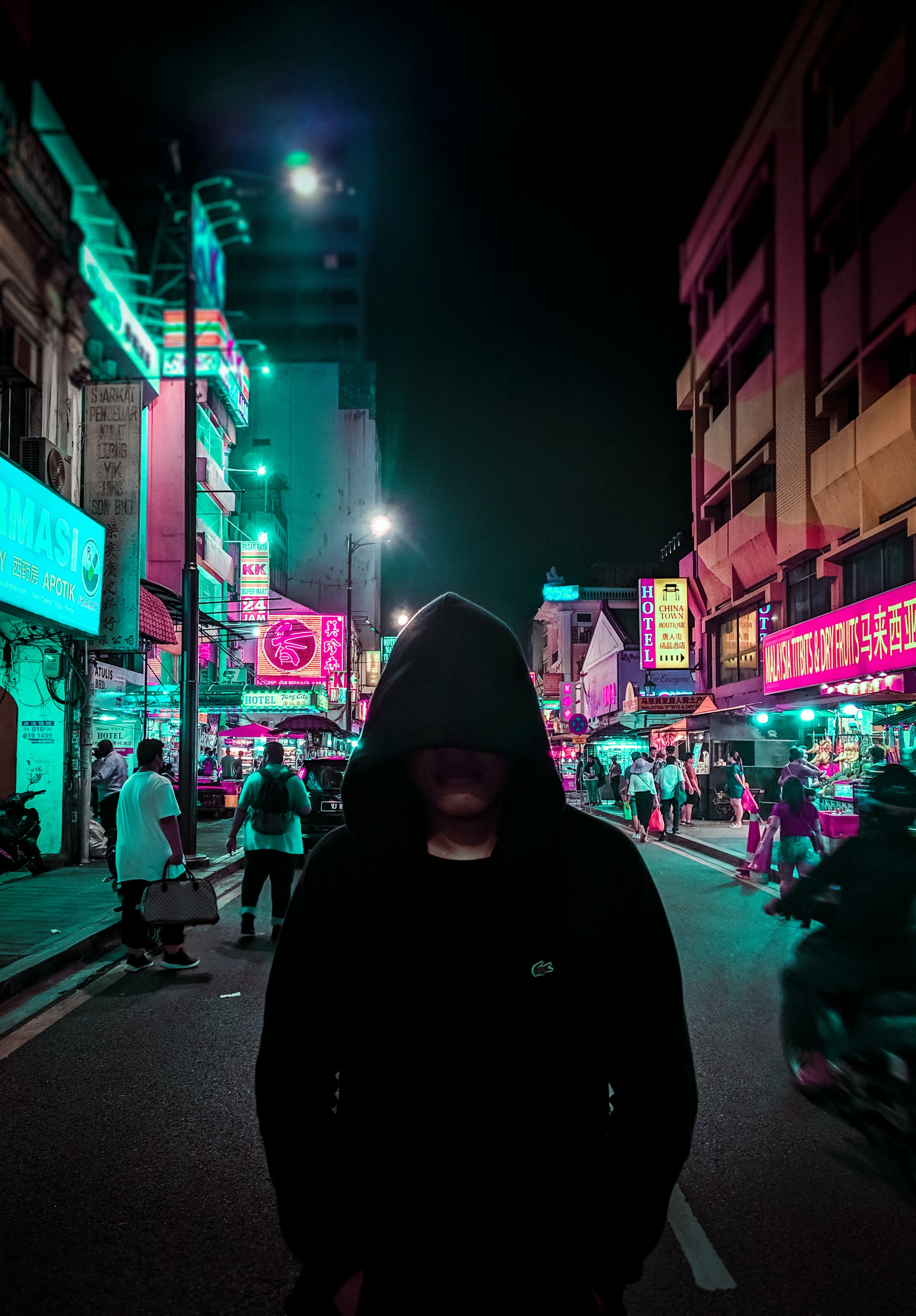 A lone figure walking a dark city street at night, standing in for a database leak walking out the door